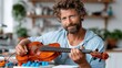 © Pinklife - A man with curly hair plays the viola in a comfortable indoor setting, showcasing a blend of music passion and a relaxed artistic atmosphere in the background.