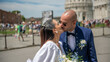 © jovannig - Wedding couple posing happily in front of iconic monuments during post-ceremony city celebration