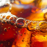 Close-up macro shot of cola bubbles and ice cubes