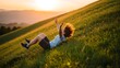© Yaqeen - Joyful young woman rolling down a grassy hill at sunset, arms outstretched in exhilaration