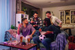 © Zamrznuti tonovi - Diverse friends gathering, watching sport, celebrating soccer and friendship at home party, enjoying drinks and snacks