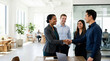 © Xenia - Multiracial business team shaking hands in a modern office. Diverse professionals reaching an agreement during a corporate meeting. Partnership and collaboration concept
