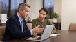 © Eve - Professional male financial advisor consulting female client with laptop in office. B2B sales representative explaining investment strategy or insurance plan during corporate meeting.
