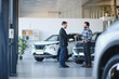 © Serhii - Salesman and customer shaking hands after car deal