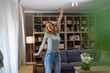 © Dexon Dee - Woman dancing freely at home feeling joy and relaxation