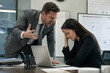 © Jørgsson Photography - Angry boss shouting at stressed office worker in modern workplace, emotional conflict, toxic leadership, workplace pressure, corporate tension, realistic business scene.