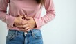 © Viktor - Woman clutches stomach in pain. She feels abdomen ache due to monthly cycle discomfort. Female suffers from cramps and distress during her period.