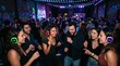 © David - Young people dancing with glowing headphones at a vibrant silent disco party in a dimly lit venue with colorful lights.