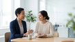 © kodidesign - Two diverse businesswomen having a meeting in a modern office. Professional Black mentor talking to a Hispanic colleague. Mentorship and collaboration in the workplace