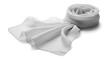 © Fick - A neatly rolled scarf lies isolated on a surface with part of it unfolded.