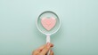 © Intellectual - Health care checkup concept, Health insurance, Access to welfare health, Wellness, Magnifying glass focus on heart and plus icon on pastel green background, Heart disease banner with copy space