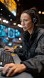 © pattozher - Focused Command Center Operator: A dedicated operator, deeply engrossed in her task, navigates complex systems, her eyes fixed on intricate data displays.