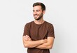© Image stock - Happy young man with a beard and arms crossed looking to the side on a white background