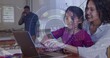© vectorfusionart - Guiding woman in rolled shirt helping child in purple top typing at kitchen table, laptop HUD