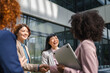 © Miljan Živković - Businesswomen shaking hands after successful team meeting outdoors