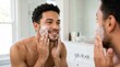 © Shiv - Man applying shaving cream to his face in front of a bathroom mirror with personal hygiene young adult domestic life