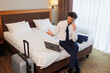 © Andrii  - Successful Businessman Celebrating While Talking on Phone and Using Laptop in Hotel Room