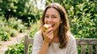 © Coosh448 - Woman enjoying a fresh apple bite for healthy living, wellness lifestyle portrait for nutrition, fitness, diet and clean eating themes, natural smile, soft daylight, crisp fruit detail, bright outdoor