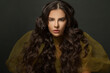 © millaf (Nemchinova) - Studio portrait of woman hair. Beautiful model with long curly hairstyle posing