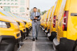 © Ljupco Smokovski - Fleet manager inspecting rows of yellow vans