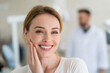 © AI_images - Woman smiling and touching her cheek while showing white teeth in dental clinic, dentist standing nearby, bright clean medical environment,