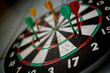 © TrueFrame Collective - Close up of darts hitting bullseye area on dartboard, representing goal achievement, precision, strategy, competition. Ideal for business targets, performance metrics, success campaigns