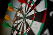© TrueFrame Collective - Close up of darts hitting bullseye on dartboard, showing accuracy, goal achievement, winning strategy, performance metrics. Ideal for business targets, success planning, KPI concepts
