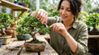 © Len_mik - Woman enjoying a focused moment while trimming a bonsai tree in a serene greenhouse setting