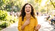 © sambath - A woman laughing in a park.