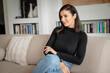 © gzorgz - Portrait of a brunette haired woman relaxing in her modern home