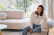 © gzorgz - Portrait of an elegant woman relaxing in an armchair in her bright, minimalist home