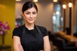 © Tanya - Smiling female stylist standing proudly in a modern hair salon, emphasizing confidence, creativity, and customer care.