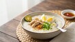 © OlgaNeuroArt - Arroz caldo chicken rice porridge with egg and fried garlic. Traditional Filipino comfort food on a wooden table. Asian cuisine concept