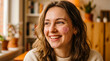 © Visual Oasis - Smiling woman with curly brown hair in cozy indoor setting. Portrait of a cheerful female enjoying a relaxed lifestyle at home