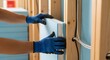 © CG - Insulation workers skilled hands fit thermal panels inside a wall cavity improving energy efficiency in a new home