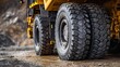 © Akash - Close-up of a large yellow heavy-duty mining dump truck tire
