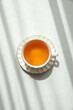 © thayra83 - Green Tea Cup on White Table under Sunlight with Shadow