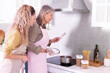 © New Africa - Mother and her daughter cooking together at countertop in kitchen
