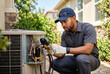© Meow Creations - Male HVAC technician repairing outdoor air conditioning unit with gauges
