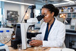 © Meow Creations - Female scientist analyzing organic wool samples under a microscope in a bright textile laboratory