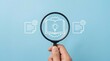© SewcreamStudio - policy review, compliance, document analysis, magnifying glass, business strategy, knowledge management, audit concept with hand holding loupe over document and light bulb icons.