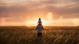 Sunset silhouette of father and child bonding in golden hour light.
