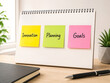 © studioROSSY - Innovation Planning and Goals Sticky Notes on Creative Office Notebook