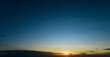 © Fahroni - Dramatic golden and dark blue sunset sky abstract background. Dark blue sky in the evening. Sky at dusk. Sunset abstract background. Dusk and dawn concept. Beauty in nature.Majestic sky for wallpaper.
