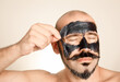 © ADDICTIVE STOCK - Male facial skincare with charcoal peel-off mask