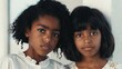 © Babb - Two young girls posing together in neutral indoor setting