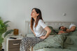© Miljan Živković - Woman experiencing stomach pain waking up husband