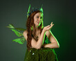 © faestock - portrait of beautiful female model wearing fantasy fairy costume, green dress,, butterfly wings and fairytale crown. isolated on dark studio background