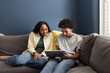 © ReeldealHD images - Two Teens Enjoying Tablet Together sitting on the couch