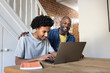 © ReeldealHD images - Father supporting son during laptop study session